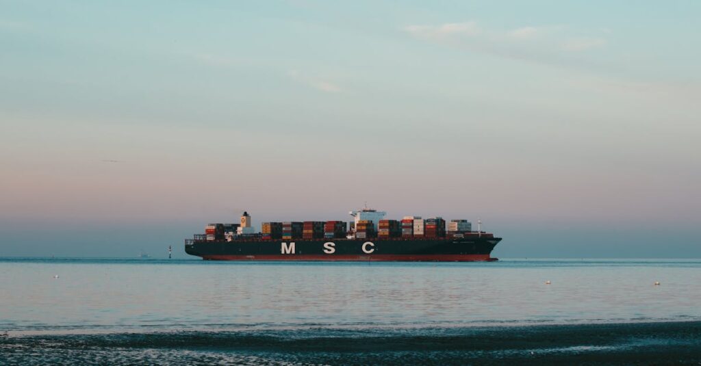 An impressive cargo ship transporting containers across a tranquil sea with a pastel sky.